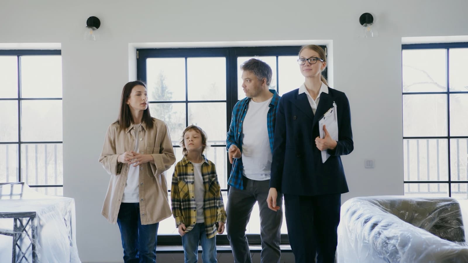 A family being shown around a house by an estate agent