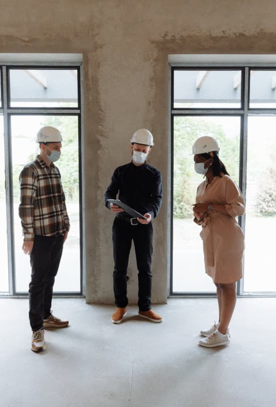 PIDS inspectors with hard hats reviewing a new-build property in Portugal before handover